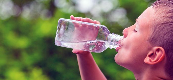 Boy Drinking Clean Tap Water From Transparent Plastic Bottle